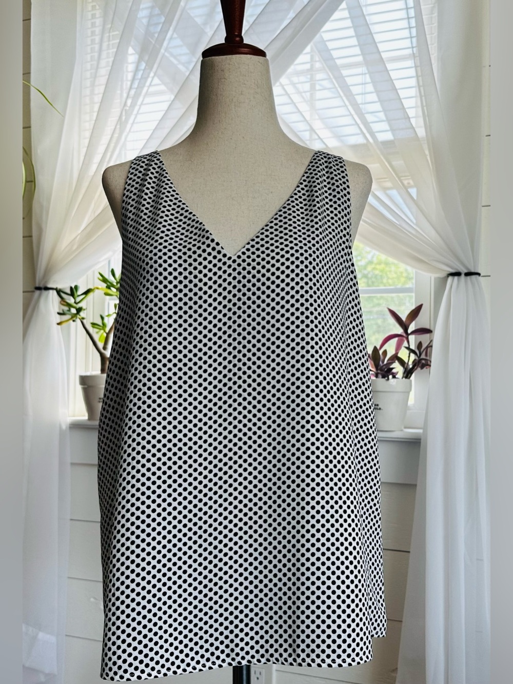 Express black and white polka dot v-neck blouse. 
Size: Medium